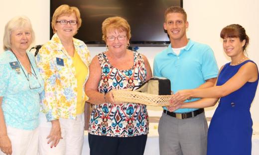 Lions Julie Thomas, Luana Beeson and Ann Bucher present school supplies to representatives from Sherwood Elementary School