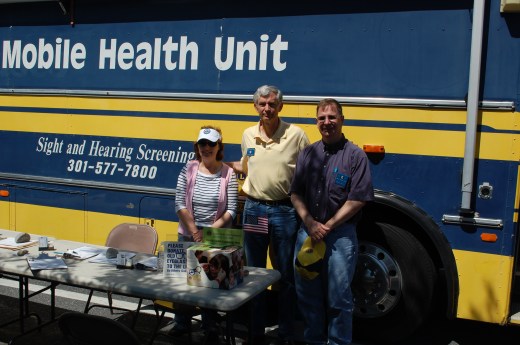 Lions Jean McCloskey, John McCloskey, and David Hull welcome community members to their free health screenings.